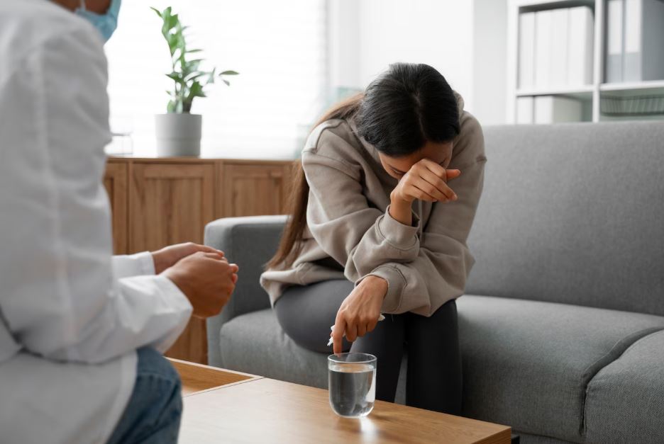 A distressed woman in a therapy session with a doctor, representing the need for Depression Medication in Fluor Central