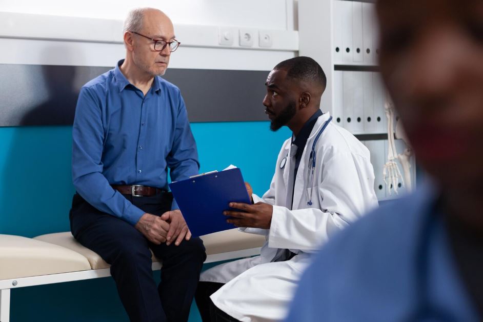 A patient consulting with an Anthem Insurance Psychiatrist in Hwy 90a Commercial Park, holding a clipboard in a modern medical office with a blue wall and medical equipment