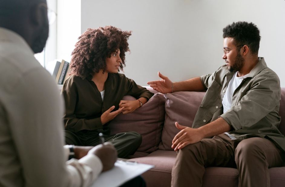 A couple having a therapy session with a mental health professional, discussing relationship challenges and mental health support, highlighting bipolar treatment at Town Center Square