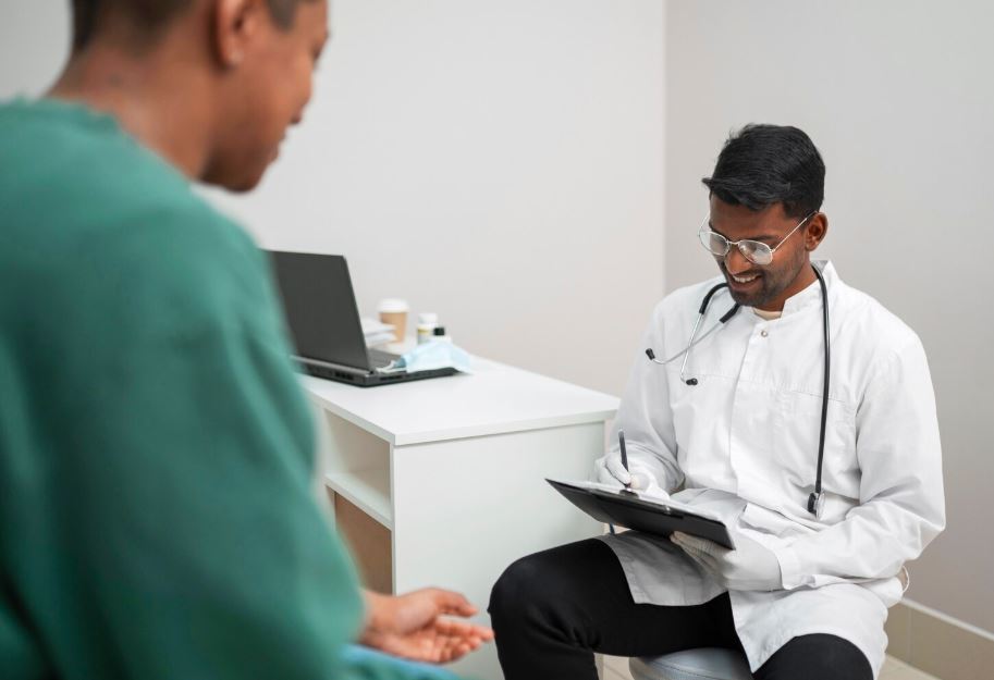 A Depression Psychiatrist in The Lakes consulting with a patient in a clinical setting, holding a clipboard and stethoscope, with a laptop and medical supplies on a desk.