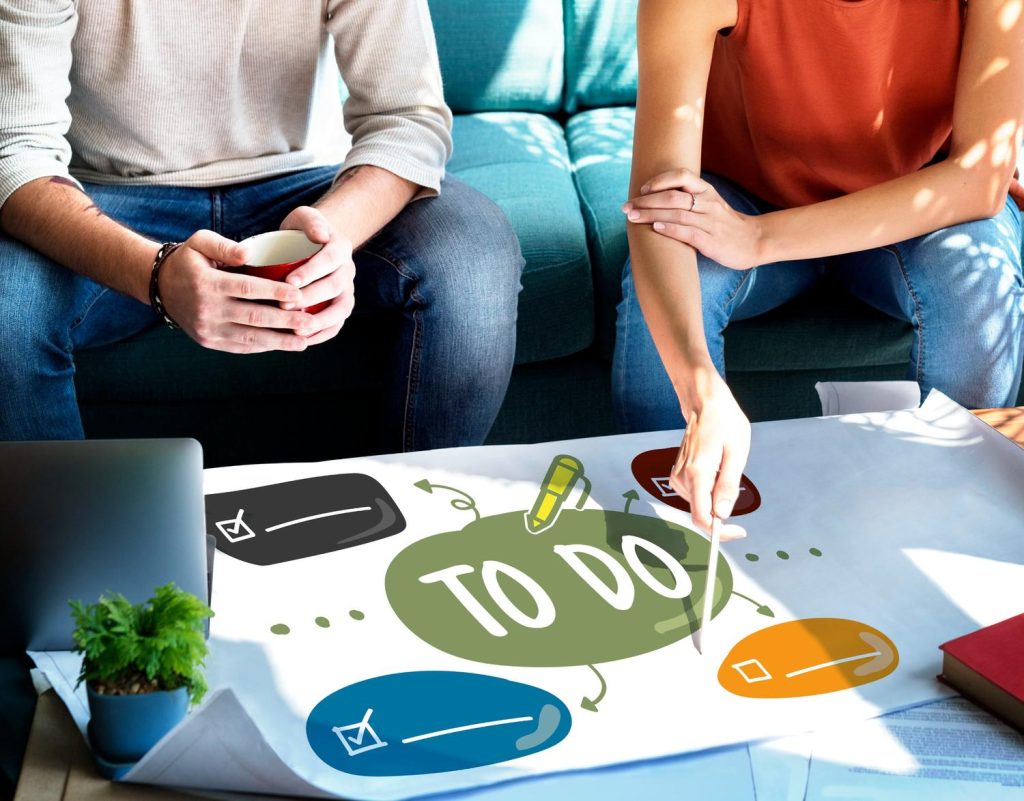 Couple discussing a to-do list on paper, planning for weekend ADHD testing in Sugar Land with flexible options.