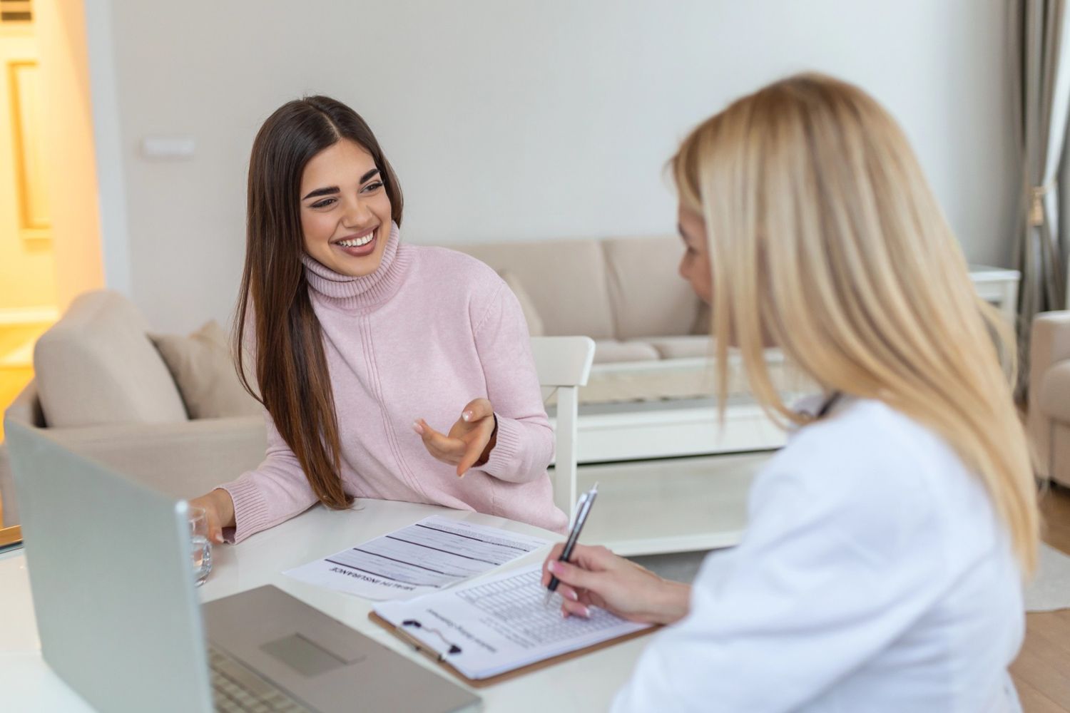 United Healthcare psychiatrist in Sugar Land writing notes and having a discussion regarding ADHD with a patient.