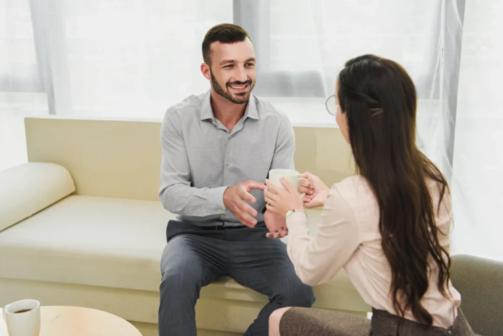 Anxiety treatment Sugar Land in relaxed setting with supportive dialogue and warm connection between two individuals.