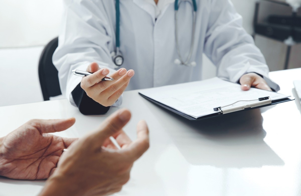 Anthem Insurance psychiatrist in Sugar Land using tablet to consult patient in modern clinic with personalized care approach.