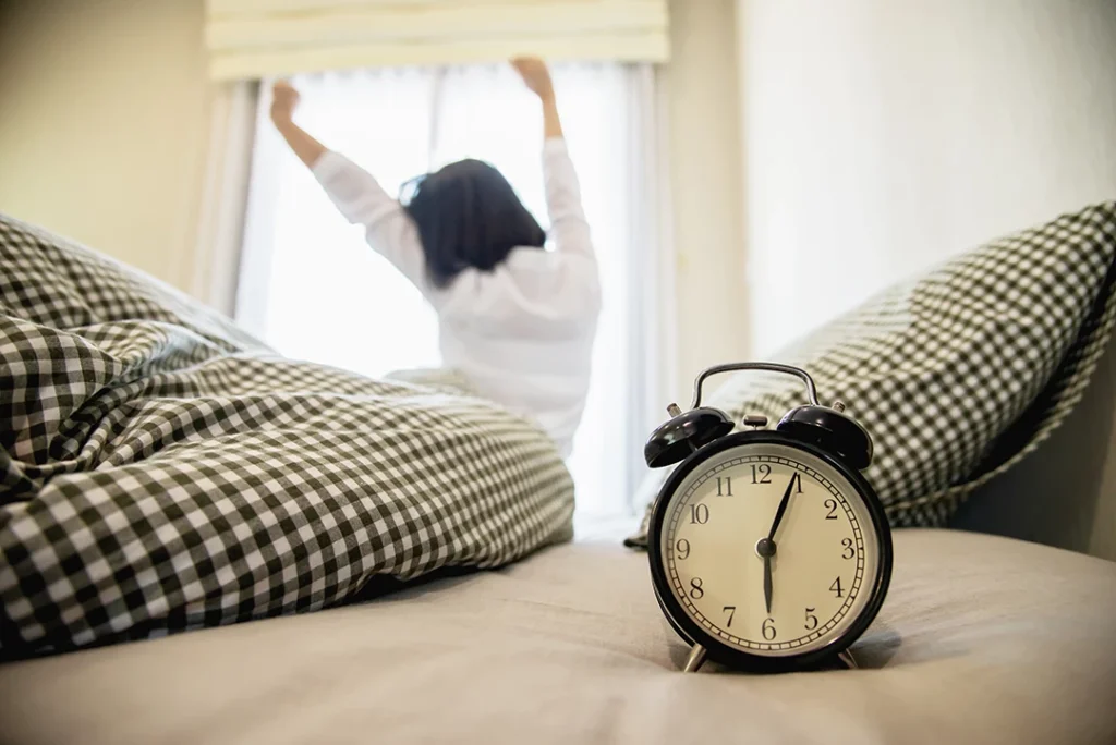 Energetic woman stretching after waking up by the window, representing improved focus and energy post weekend ADHD testing in Sugar Land.