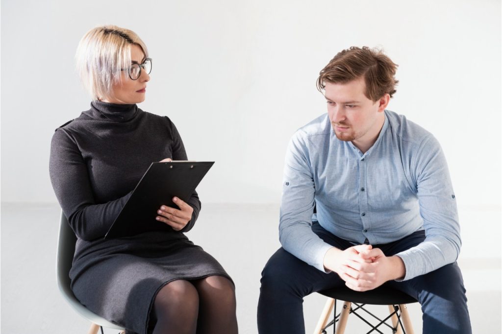 Expert Aetna Psychiatrist Sugar Land provider taking medical notes during a mental health evaluation