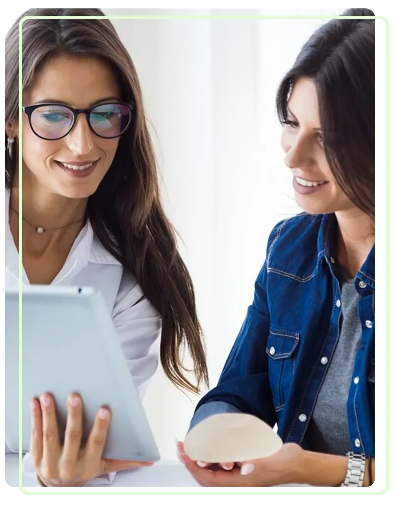 A mental health professional showing a digital tablet to a smiling patient during a session for affordable bipolar treatment in Sugar Land.