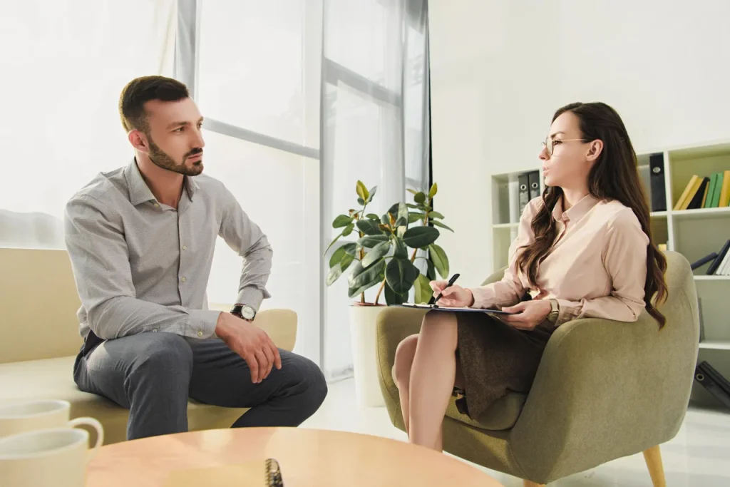 Patient discussing mental health during a session with anxiety doctors Sugar Land in a bright, modern office setting.