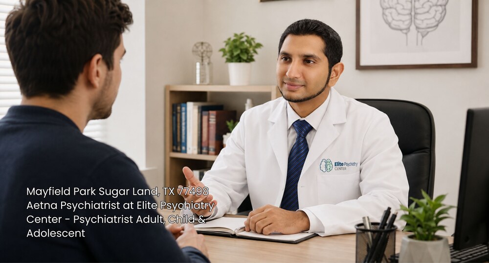 An Aetna psychiatrist Sugar Land doctor consulting with a male patient at Elite Psychiatry Center in his office.